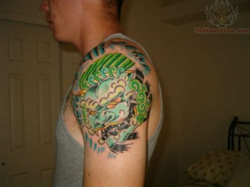 Green ink Foo Dog Tattoo On Shoulder